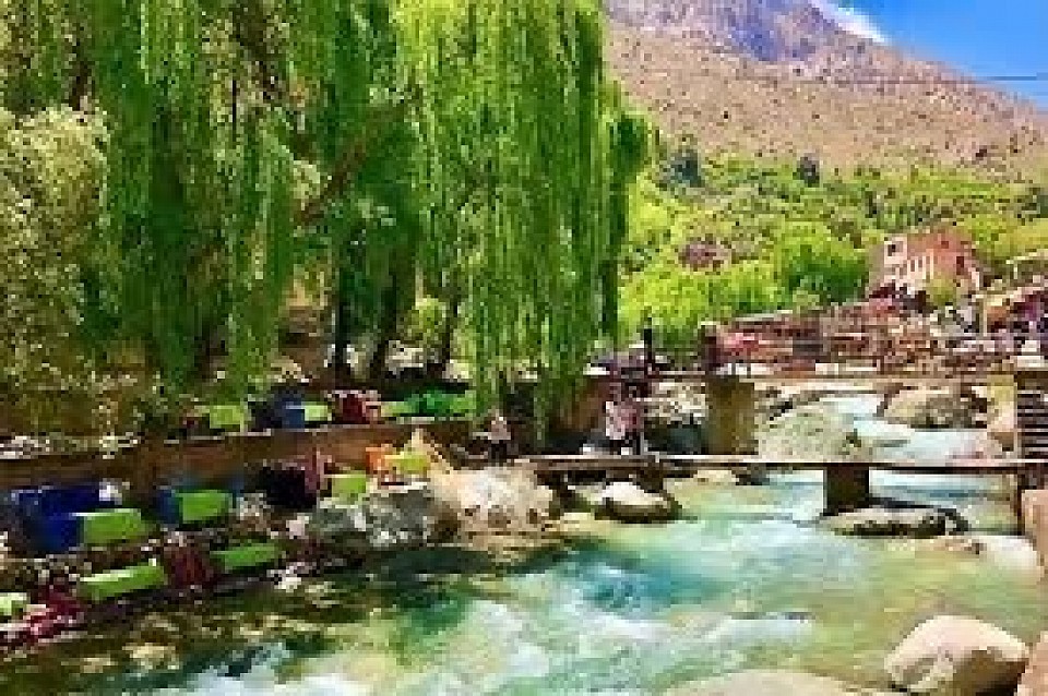 DAY TRIP TO THE OURIKA VALLEY FROM MARRAKECH Prepare for a captivating adventure as your departure is meticulously scheduled around 9 am. Your destination? The picturesque Ourika Valley, a breathtaking haven nestled just 64 km away from the bustling Marrakech. This enchanting valley promises a journey of a lifetime through its winding roads, nestled amidst the towering Atlas Mountains and adorned by the tranquil Ourika River. A place of solace and rejuvenation cherished by both locals and visitors, the valley boasts sprawling orchards and verdant landscapes, graciously situated to the southeast of Marrakech.